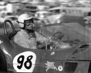Carroll Shelby driving a vintage Maserati race car with number 98 on a track