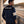 Back view of model in Red X Thread Shelby American apparel, showing the premium construction and detailing of officially licensed heritage motorsport clothing.