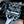 Close-up of a Shelby Cobra engine with visible branding on a blurred background