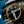 Close-up of a vintage Shelby Cobra steering wheel and dashboard with gauges.