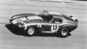 Vintage Shelby Cobra Daytona Coupe race car with number 13 on a track