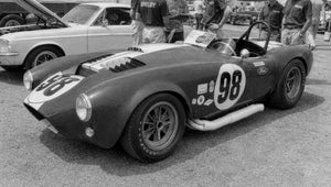 Vintage Shelby Cobra race car with number 98 at a track